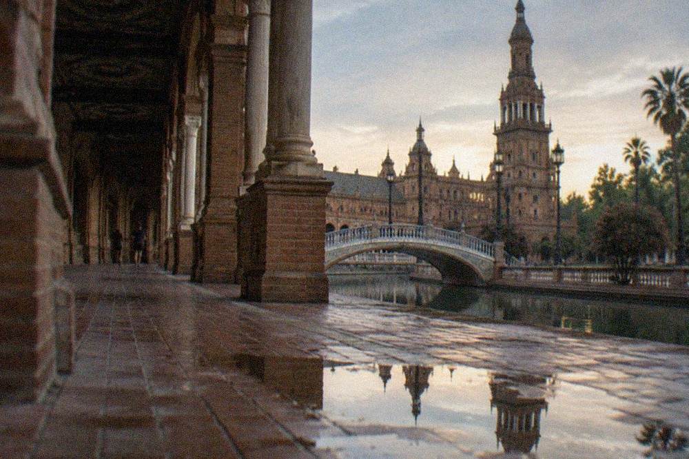 The semicircular building of the Plaza de España with its canal and tiled bridges
