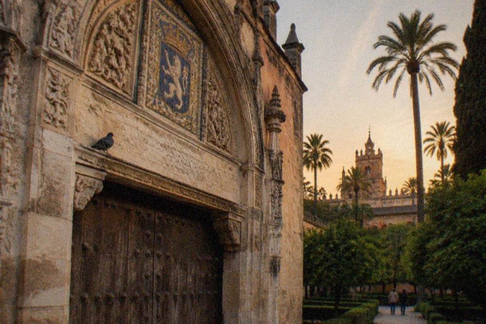 Carved stone archways and patterned tilework inside the Real Alcázar palace