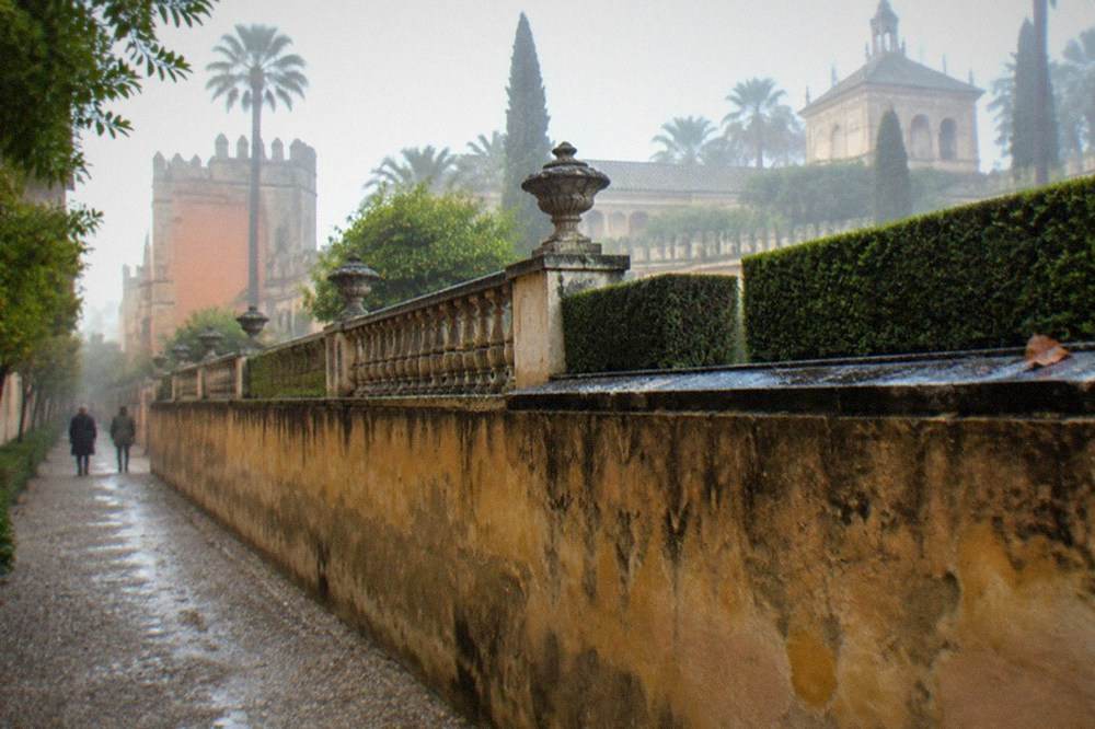 Formal gardens with trimmed hedges and fountains at the Real Alcázar
