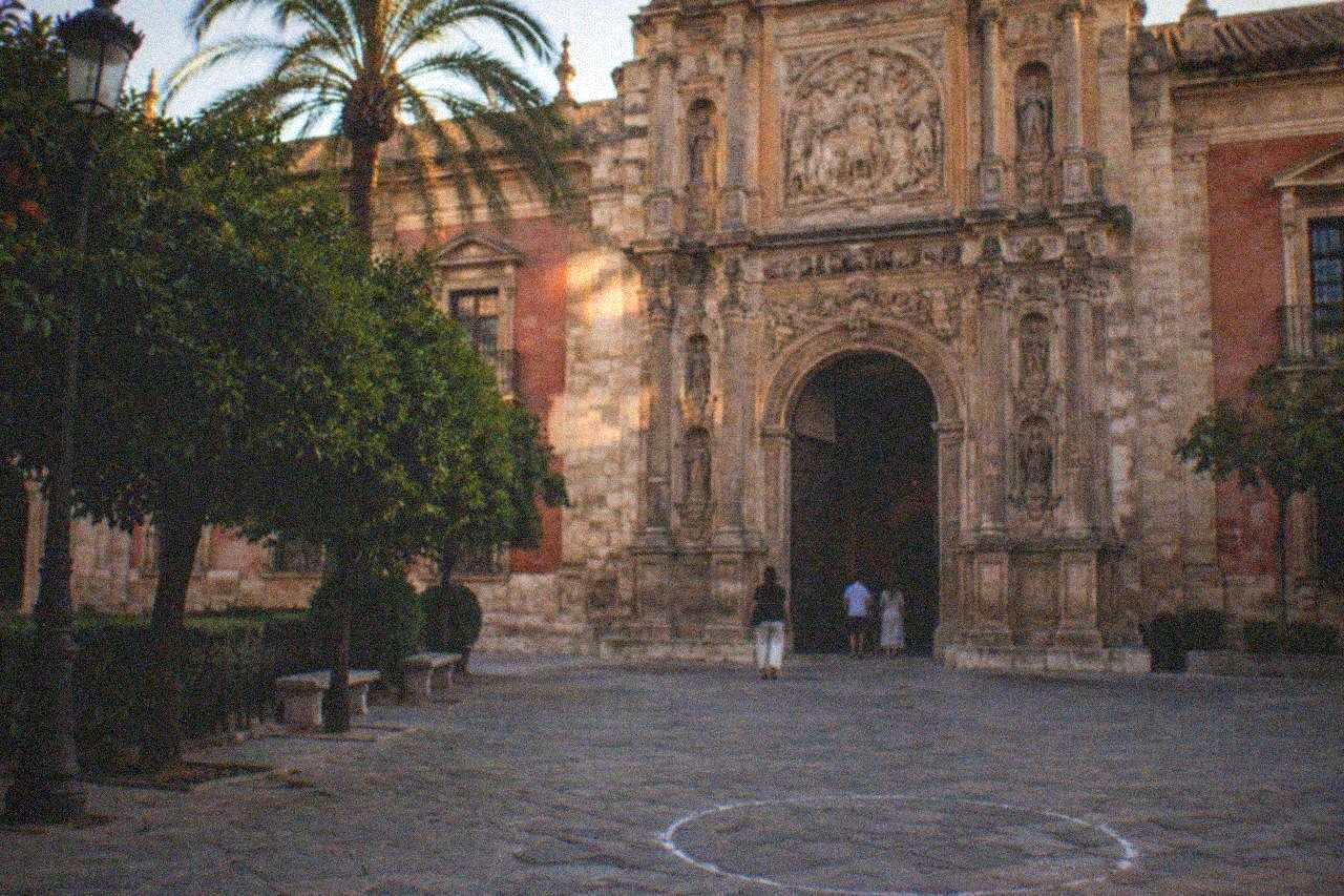 Paintings hanging on the walls of the gallery halls in a Seville fine arts museum
