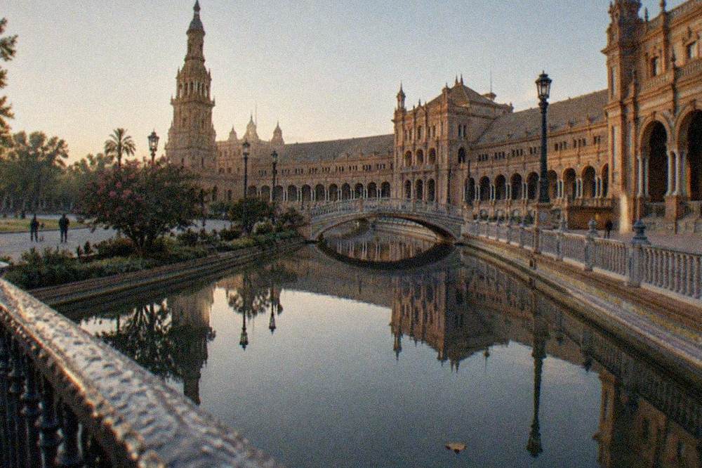 Plaza de Espana building reflected in the canal on a quiet morning