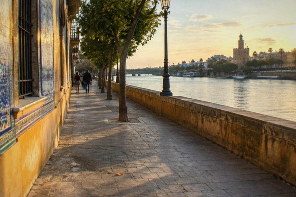 Tiled facades along a Triana street seen from the riverbank