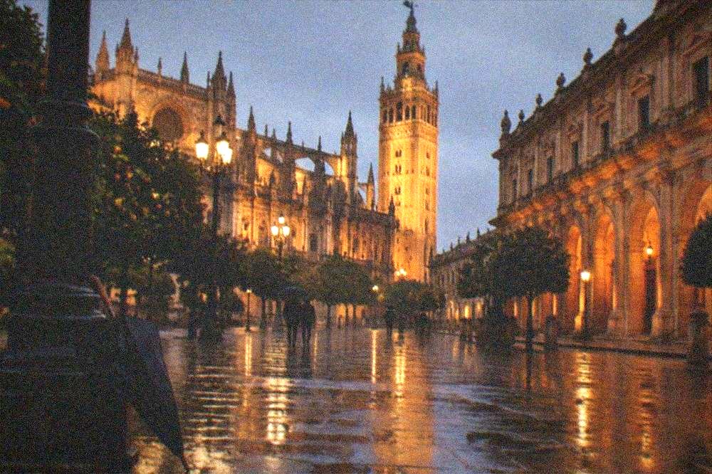 Lit facades around an evening plaza in the historic centre