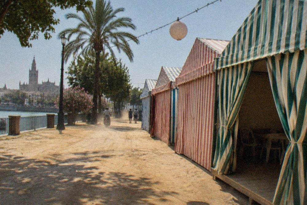 Rows of striped caseta tents and paper lanterns along fairground lanes in Seville