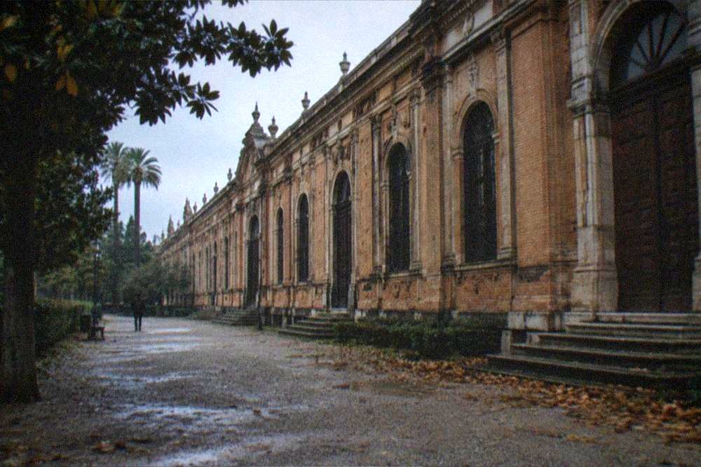 A shuttered museum facade with closed doors in Seville