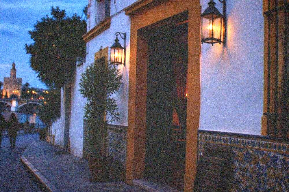 Lanterns and tiled facade of a flamenco show room in Triana