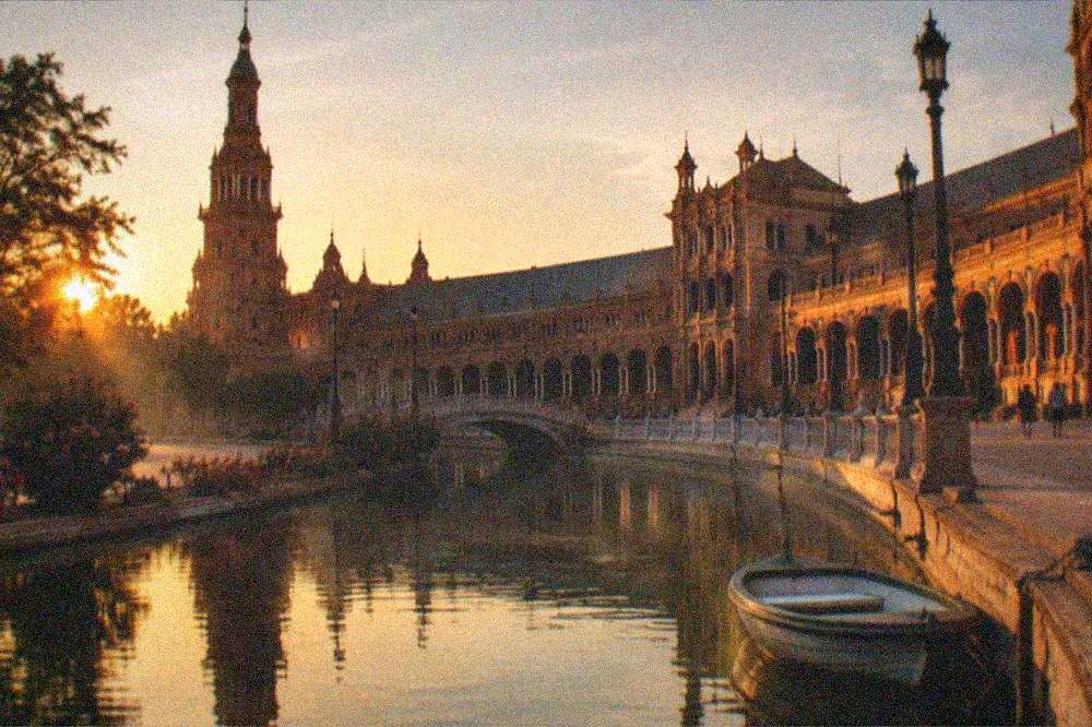 Evening light on the arcades and canal of Plaza de España
