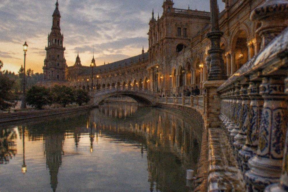 Plaza de España seen in the late evening with its arcade and water basin