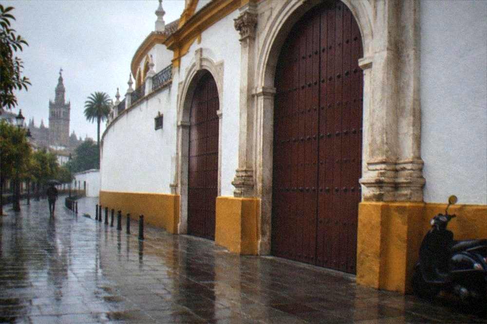 The closed wooden entrance gates of the Seville bullring on a quiet morning