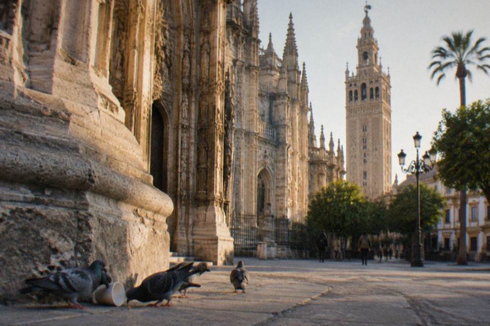 The west front of Seville Cathedral seen from the square outside, stone facade in daylight