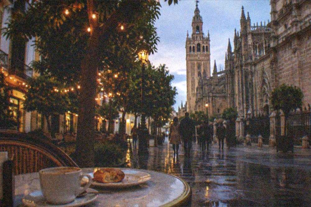 Evening table with coffee and pastries beside a city street