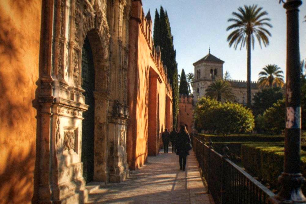 Hedged gardens and tiled arches inside the Real Alcázar