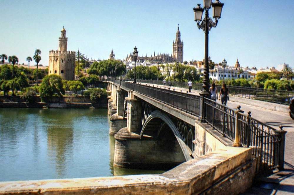The Puente de Triana bridge over the Guadalquivir river at midday