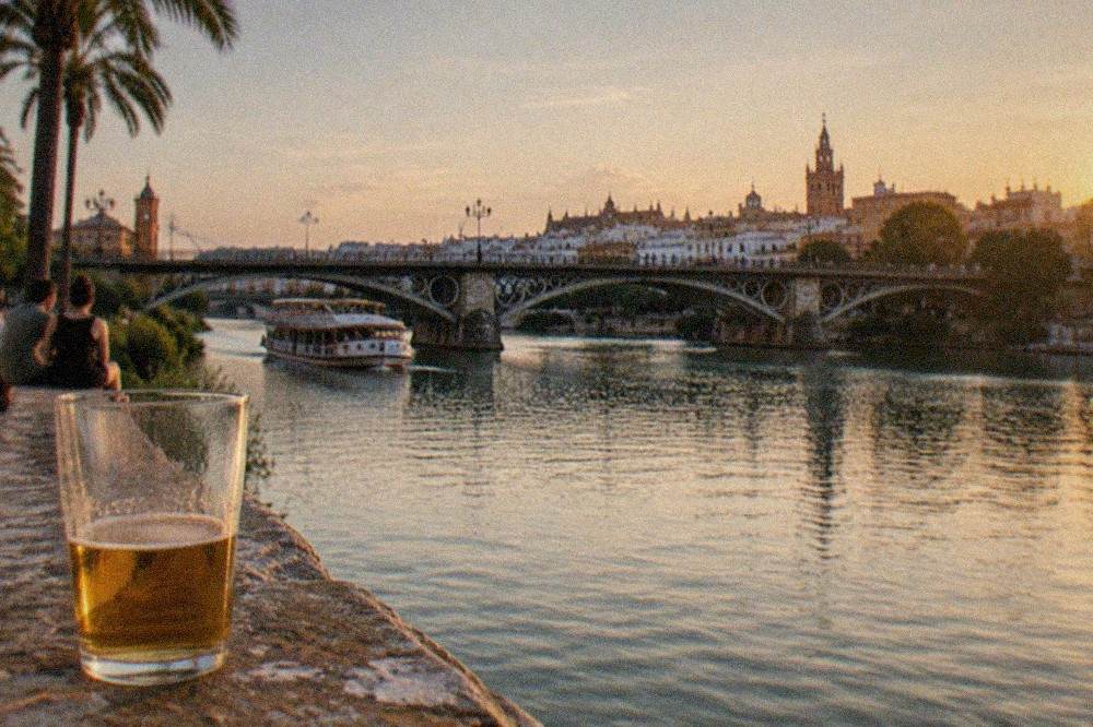 The Puente de Triana spanning the Guadalquivir River with Triana buildings behind it