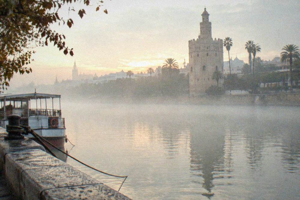 The Torre del Oro seen from the Guadalquivir riverfront at dusk